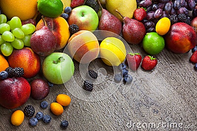 Mixed fresh Fruits on the wooden background with water drops Stock Photo
