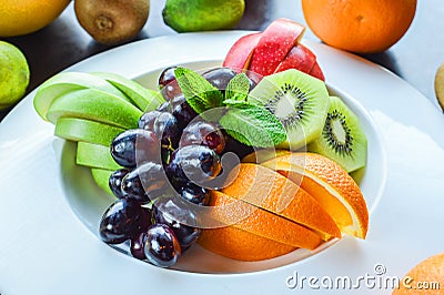 Mixed fruit salad in a white plate on the light Stock Photo