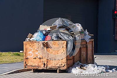 Mixed garbage in large quantities in the construction container. Sorting, Zero waste. second hand space. Recycling mixed material Editorial Stock Photo