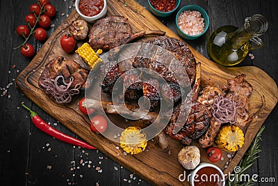 Mixed grilled meat platter on a black background Stock Photo