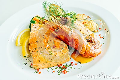 Mixed grilled seafood steak with salmon prawn and other meat Stock Photo