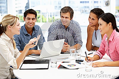 Mixed group around table in business meeting Stock Photo