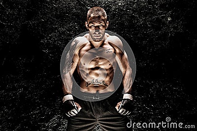 Mixed martial artist posing on a black background. Concept of mma, ufc, thai boxing, classic boxing Stock Photo