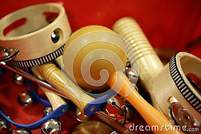 Mixed percussion toy instruments on red Stock Photo