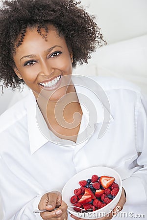 Mixed Race African American Woman Eating Fruit Stock Photo