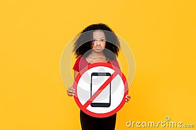 Mixed race African girl showing no mobile phone usage sign Stock Photo