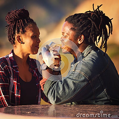 Mixed race couple of African descent making an intertwined toast Stock Photo