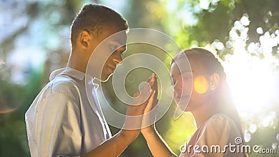 Mixed-race couple in love putting hands together in park, trustful relations Stock Photo