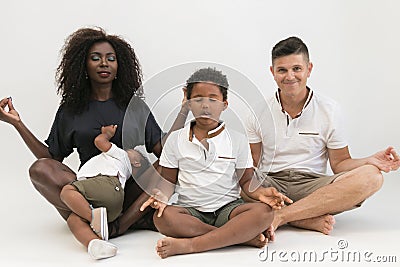 Mixed race family meditation relaxing with yoga. Balanced life c Stock Photo