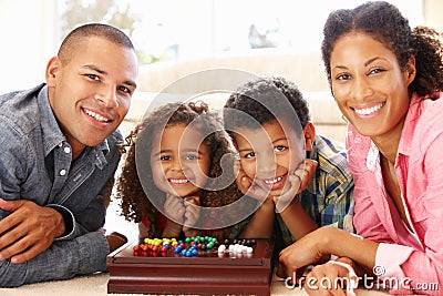 Mixed race family playing solitaire Stock Photo