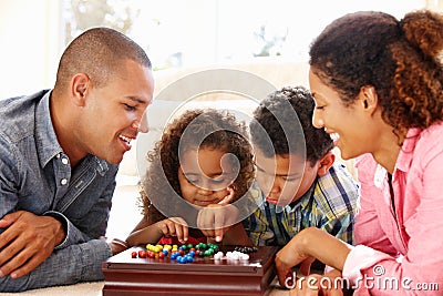 Mixed race family playing solitaire Stock Photo