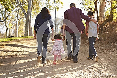 Mixed race family walking on rural path, close up back view Stock Photo