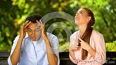 Mixed-race guy shocked by too talkative and annoying girl during first date Stock Photo