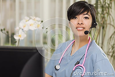 Mixed Race Nurse Practitioner or Doctor at Computer Stock Photo