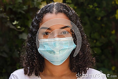 Mixed Race Teenager Girl Woman Wearing Coronavirus COVID-19 Face Mask Stock Photo