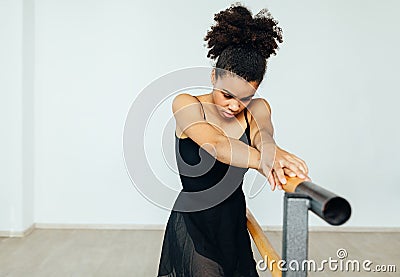 Mixed race woman in dancewear resting Stock Photo