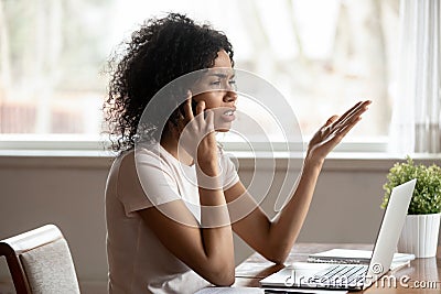 Mixed race woman having difficult conversation by mobile phone Stock Photo