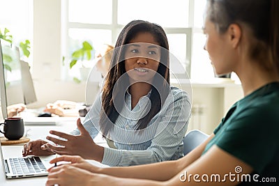 Mixed race woman mentor explaining new employee principles of work Stock Photo