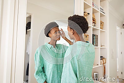 Woman looking in the mirror Stock Photo