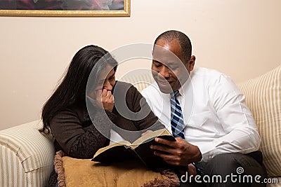 Mixed Raced Christian Couple Studying Bible Together Stock Photo