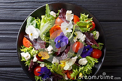 Mixed salad of edible flowers with lettuce, tomatoes and cream c Stock Photo