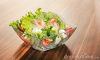 Mixed salat in a glass bowl isolated on white. Stock Photo