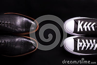 Mixed shoes. Oxford and sneakers shoe on black background. Different style of men fashion. Compare formal casual. Top view. Cop Stock Photo