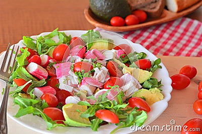 Mixed vegetable salad with crab sticks and avocado Stock Photo