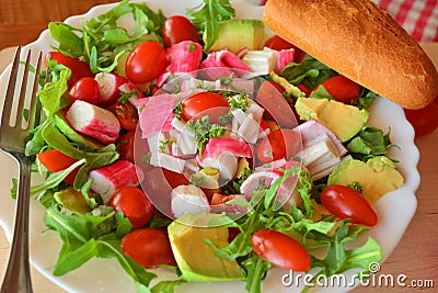 Mixed vegetable salad with crab sticks and avocado Stock Photo