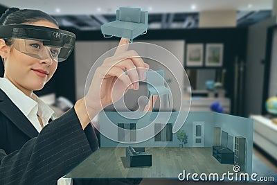 Mixed virtual reality concept, woman hold the simulation furniture to decorate the room for management and adjust in the smart ret Stock Photo