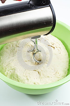 Mixer mixes the dough in a large cup on white, dough preparation Stock Photo