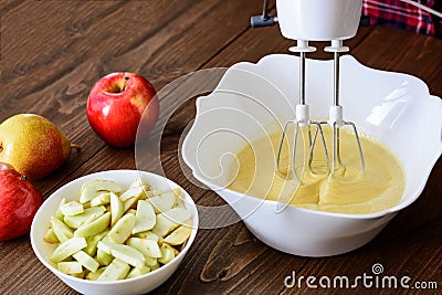 Mixing Batter or dough for apple-pear cake or muffin or pancake. Close up in wooden table c ingredients Stock Photo