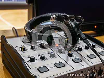 Mixing console and headset at the workplace of a sports commentator Stock Photo