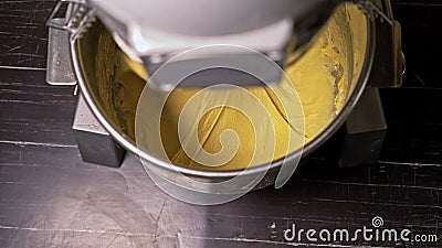 Mixing dough for bread baking with professional kneader spiral machine at the manufacturing. The dough is kneaded for Stock Photo