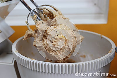 Mixing egg, flour and sugar in bowl with electric mixer Stock Photo