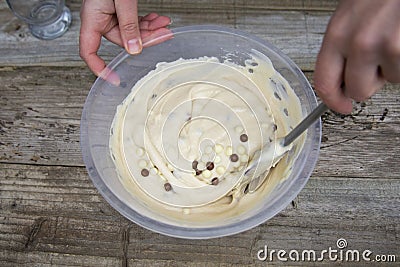 Mixing raw dough in bowl. Baking cake, muffin or homemade pastry Stock Photo