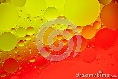 Mixing water and oil, beautiful color abstract background based on red and yellow circles and ovals, macro abstraction Stock Photo