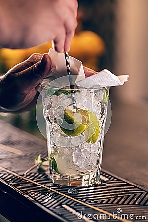 Mixologist barman making mixed alcoholic cocktail Stock Photo
