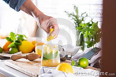 Mixologist making refreshing cocktail with hard seltzer at home Stock Photo