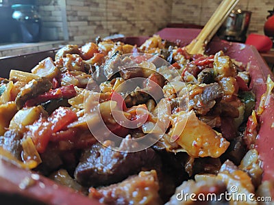 Mixture of fried vegetables and meat ready to go into the oven Stock Photo