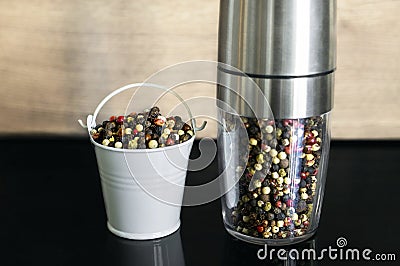 A mixture of pepper varieties in a pepper mill. Heap of various pepper. Mix of red, black, and white peppercorn seeds Stock Photo