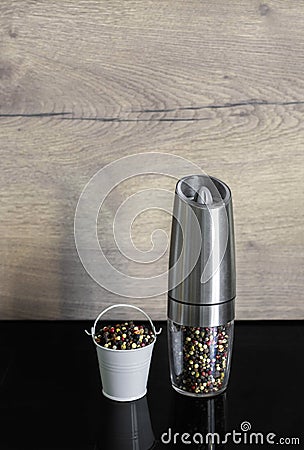 A mixture of pepper varieties in a pepper mill. Heap of various pepper. Mix of red, black, and white peppercorn seeds Stock Photo