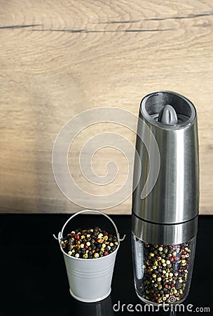 A mixture of pepper varieties in a pepper mill. Heap of various pepper. Mix of red, black, and white peppercorn seeds Stock Photo