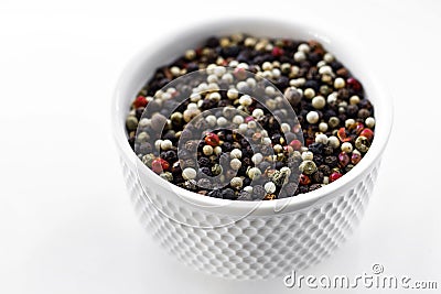 A mixture of pepper varieties with peas on the white plate on the white background. Heap of various pepper. Mix of red Stock Photo