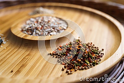 Mixture of spices for baking on a wooden plate. Includes flax sesame and sunflower seeds Stock Photo