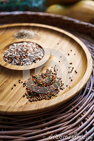 Mixture of spices for baking on a wooden plate. Includes flax sesame and sunflower seeds Stock Photo