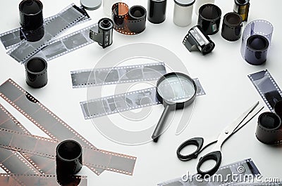 35 mm photographic film, negatives, magnifying glass and scissors Stock Photo