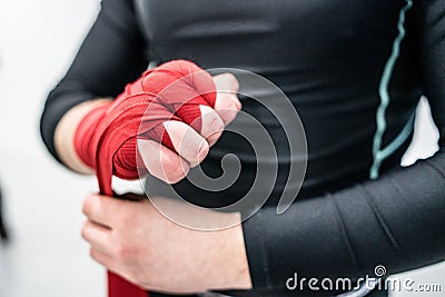 MMA boxing fighter putting hand wraps on hands Stock Photo