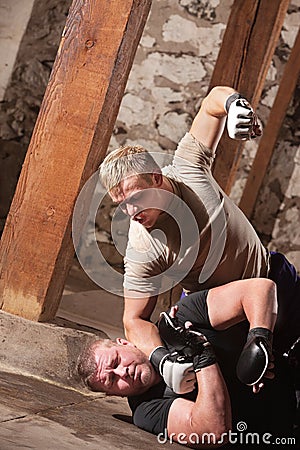MMA Fighter Beating Opponent Stock Photo