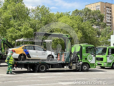 Moscow, Russia, June, 01, 2022. Carsharing car `Yandex Drive` was loaded onto a tow truck on the street of the Soviet Army in Mosc Editorial Stock Photo